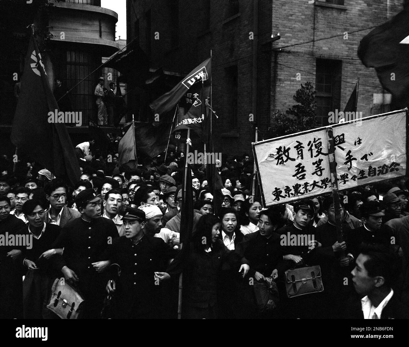 Flags are those of leftist unions, one bearing the inscription ...