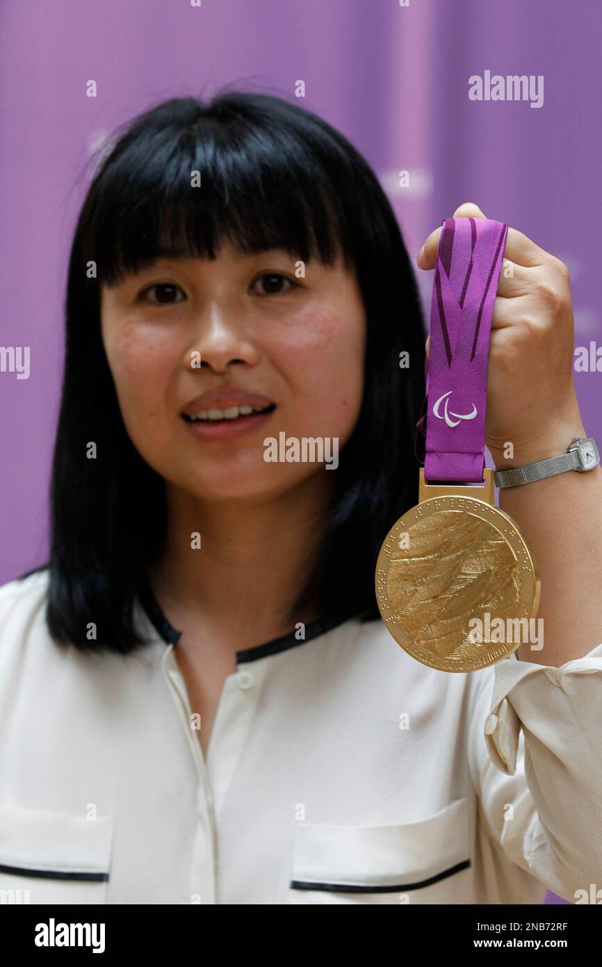 Lin Cheung, jewellery artist and the medals' designer, holds a gold ...