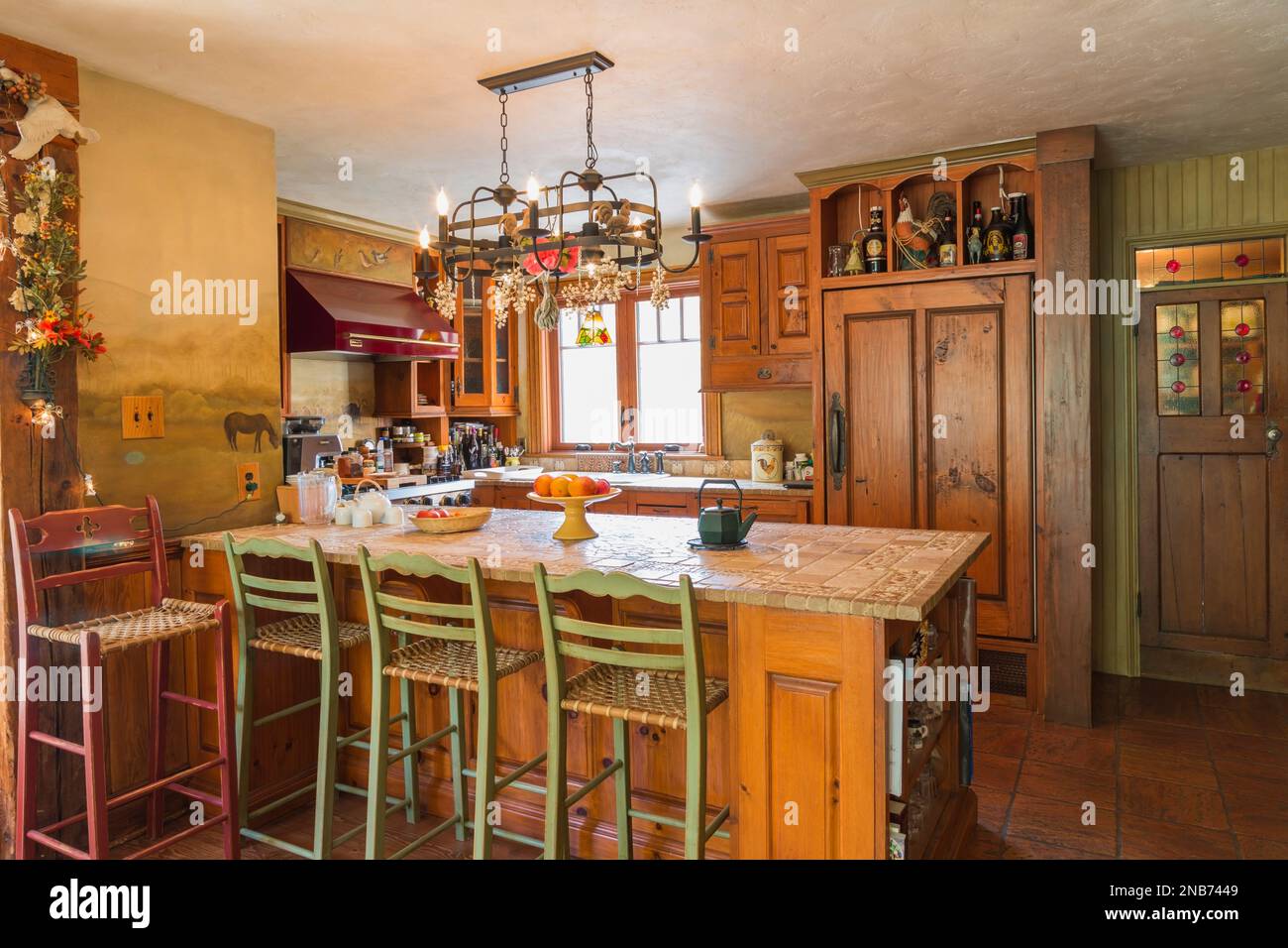 Stone and inlaid ceramic tile top pinewood island with wood and woven