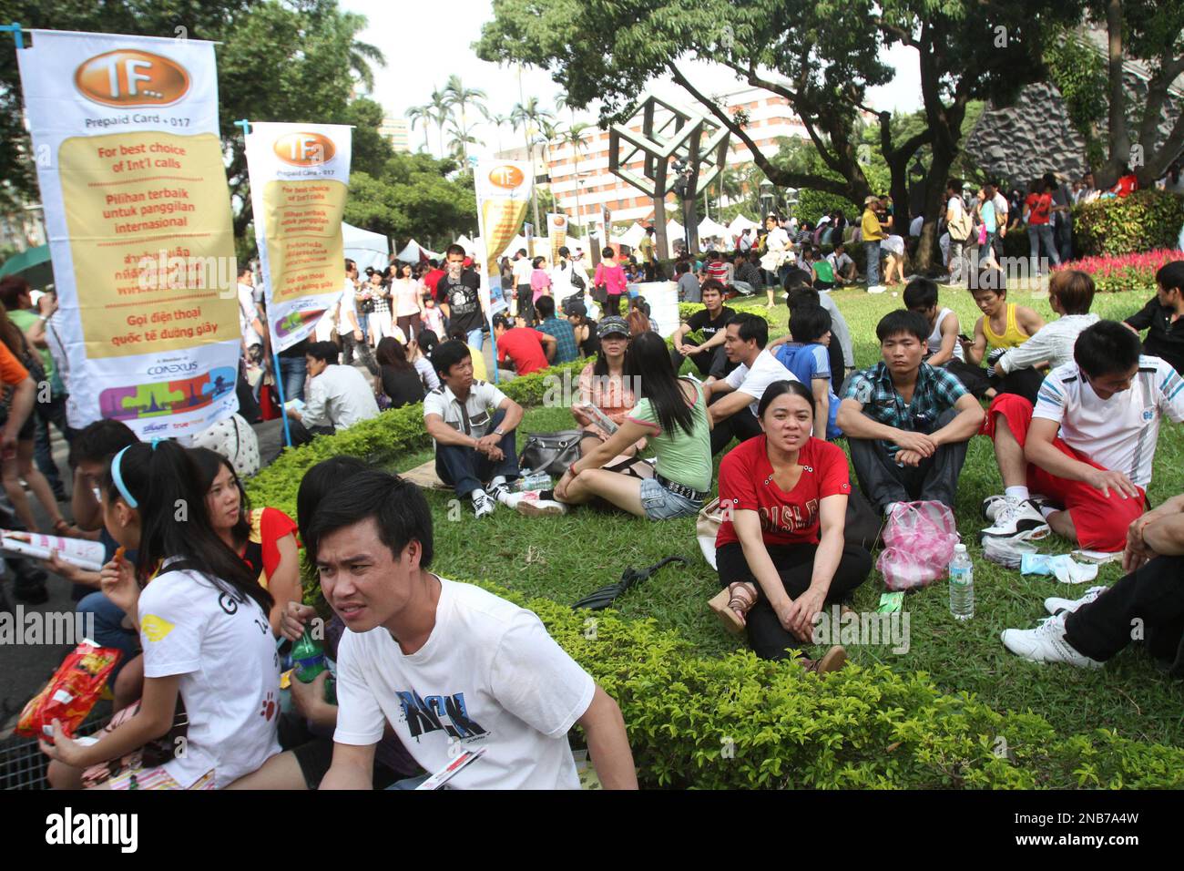 Vietnamese living in Taiwan sit on the lawn during a Vietnamese