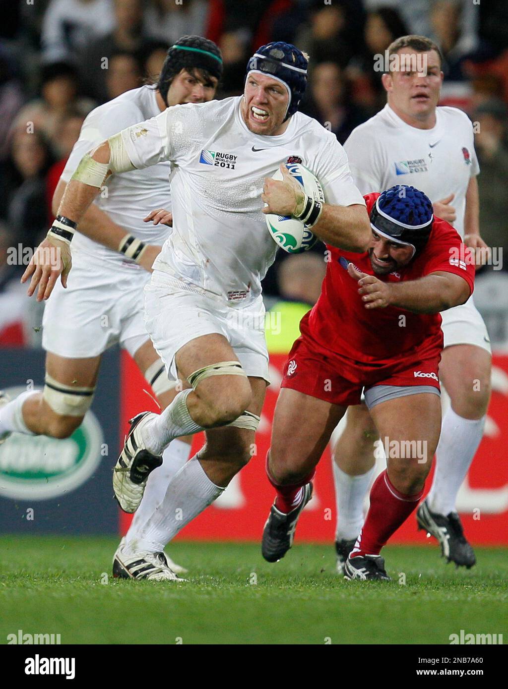 England's James Haskell, left, runs past Georgia's Davit ...