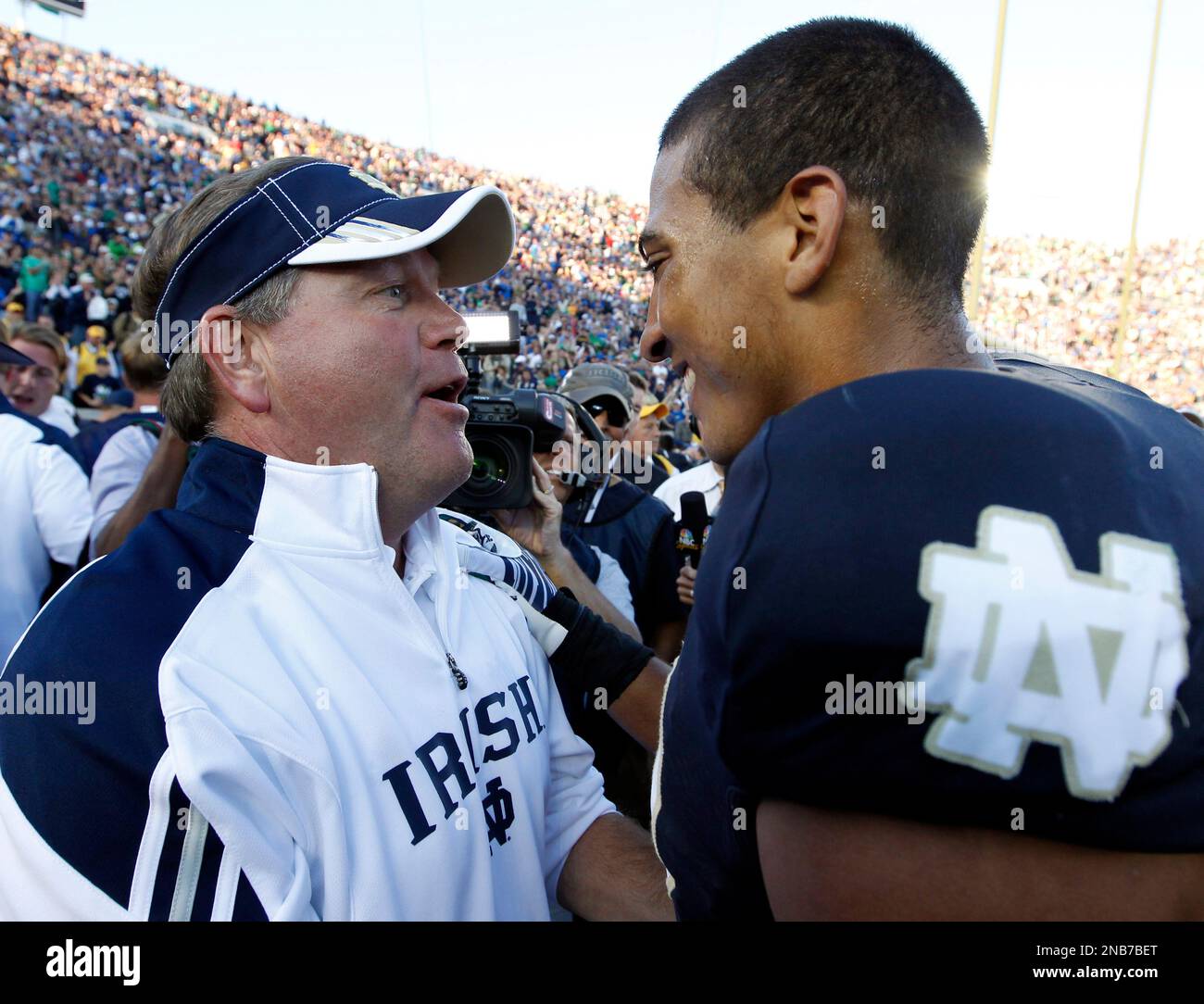 Notre Dame head coach Brian Kelly, left, congratulates cornerback Robert Blanton after a 31-13 win over Michigan State in an NCAA college football game in South Bend, Ind., Saturday, Sept. 17, 2011. (AP Photo/Michael Conroy) Stock Photo