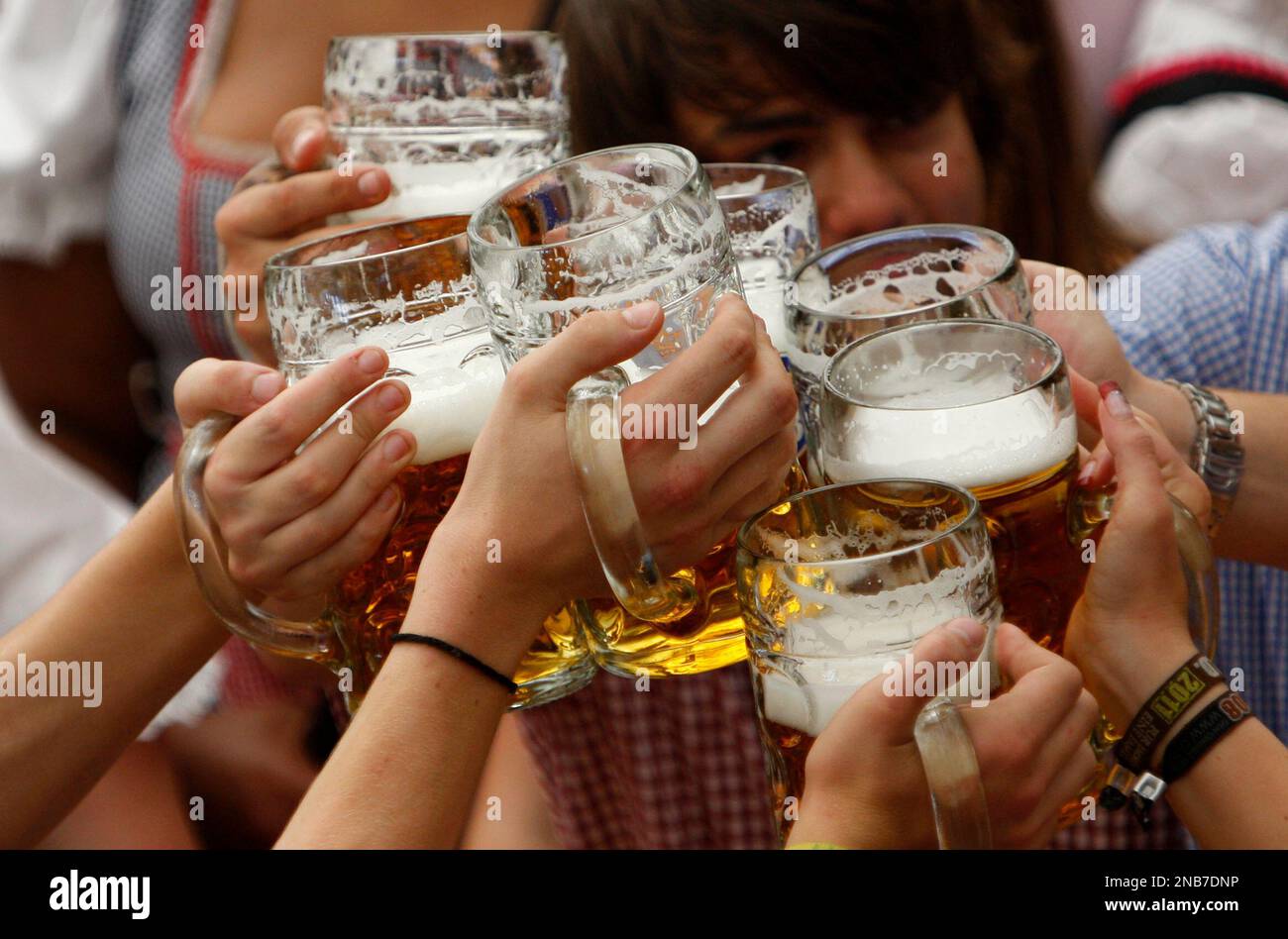 Visitors lift their beer mugs in the Hofbraeuhaus-tent after the opening of famous Bavarian "Oktoberfest" beer festival in a beer tent in Munich, southern Germany, on Saturday, Sept.17, 2011. The world's
