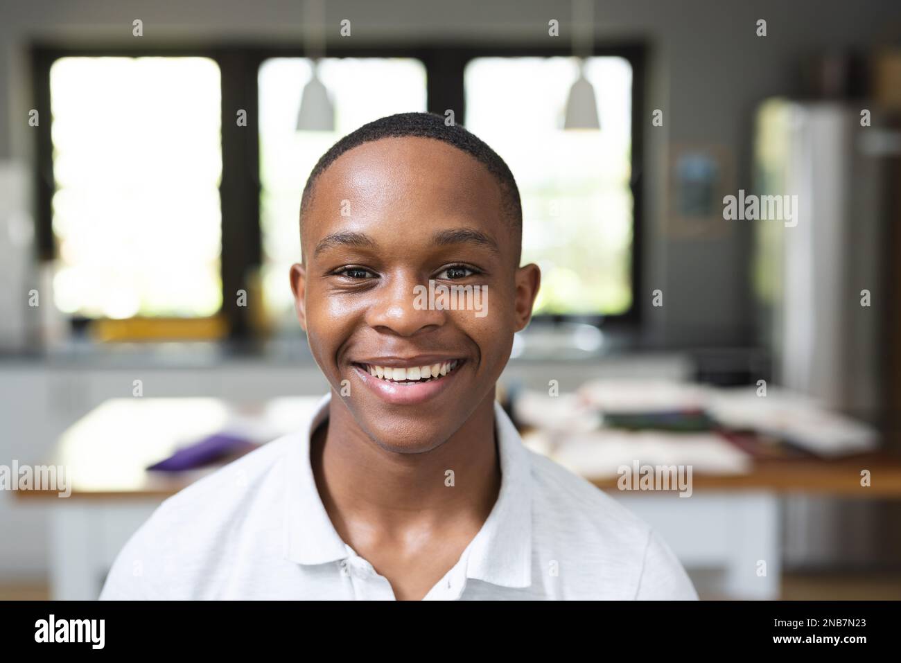 Image of happy african american teenage boy looking at camera. Teenagers, adolescence and lifestyle concept. Stock Photo