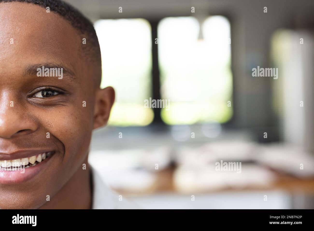 Image of happy african american teenage boy looking at camera. Teenagers, adolescence and lifestyle concept. Stock Photo