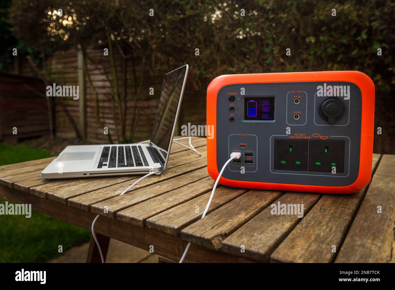 Portable power station solar electricity generator outdoors with laptop