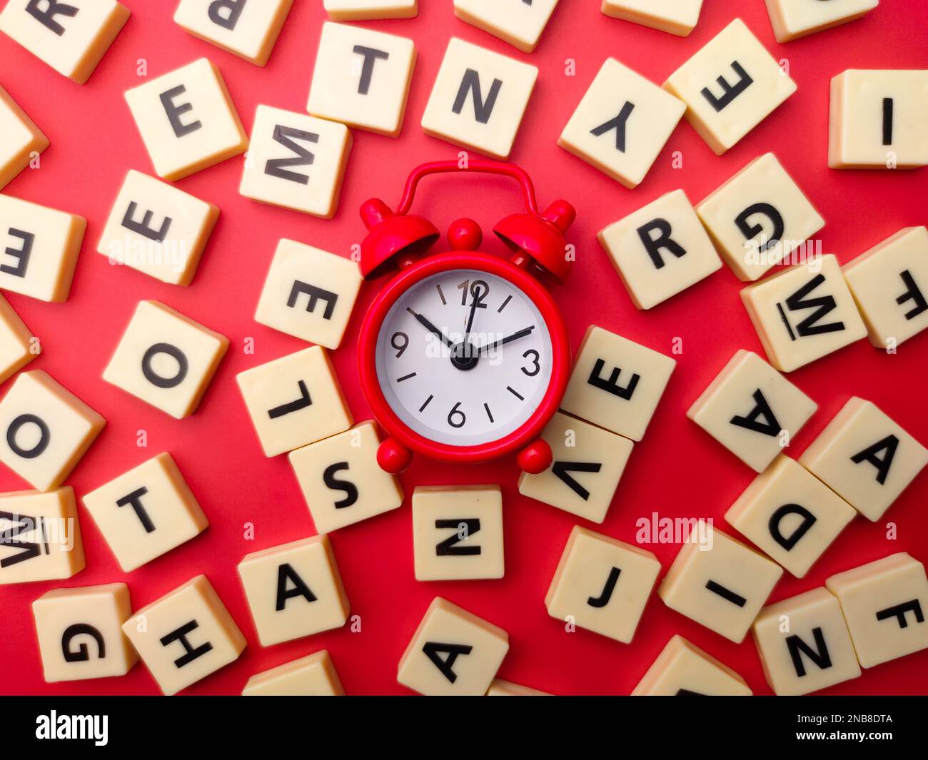Toys word and alarm clock on a red background Stock Photo - Alamy
