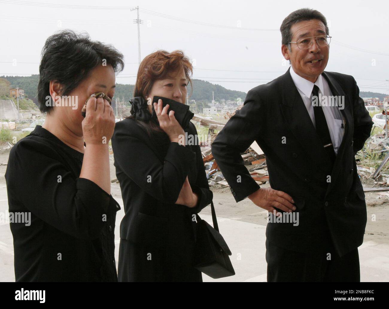 Seiki Endo, right, his wife Mieko, left, and Hiromi Miura are overcame