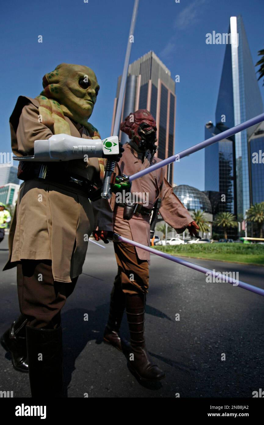 Two Star Wars film fans dressed as alien Jedi Kit Fisto, left, and Jedi master Plo Koon participate in a march celebrating the anticipated release of the saga in Blu-ray, in Mexico City, Saturday Sept. 10, 2011. Star Wars: The Complete Saga on Blu-Ray will be released on Sept. 16. (AP Photo/Marco Ugarte) Stock Photo