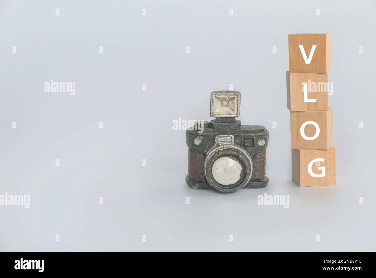 Vlog concept with camera and a stack of wooden cube written with VLOG. Stock Photo