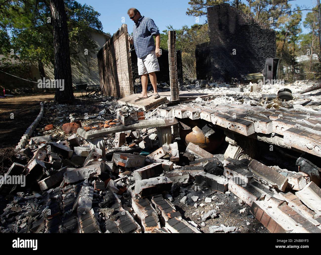 Robert King looks through the remains of her home that was destroyed by  wildfires, Thursday, Sept. 8, 2011, in Bastrop, Texas. The fire has  destroyed more than 1,000 homes and blackened about