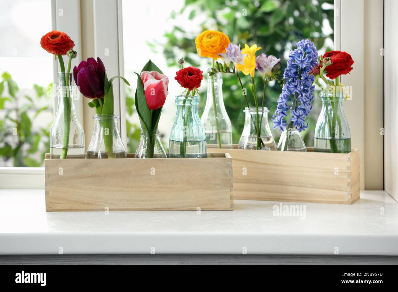 Beautiful spring flowers in wooden crates on window sill Stock Photo ...