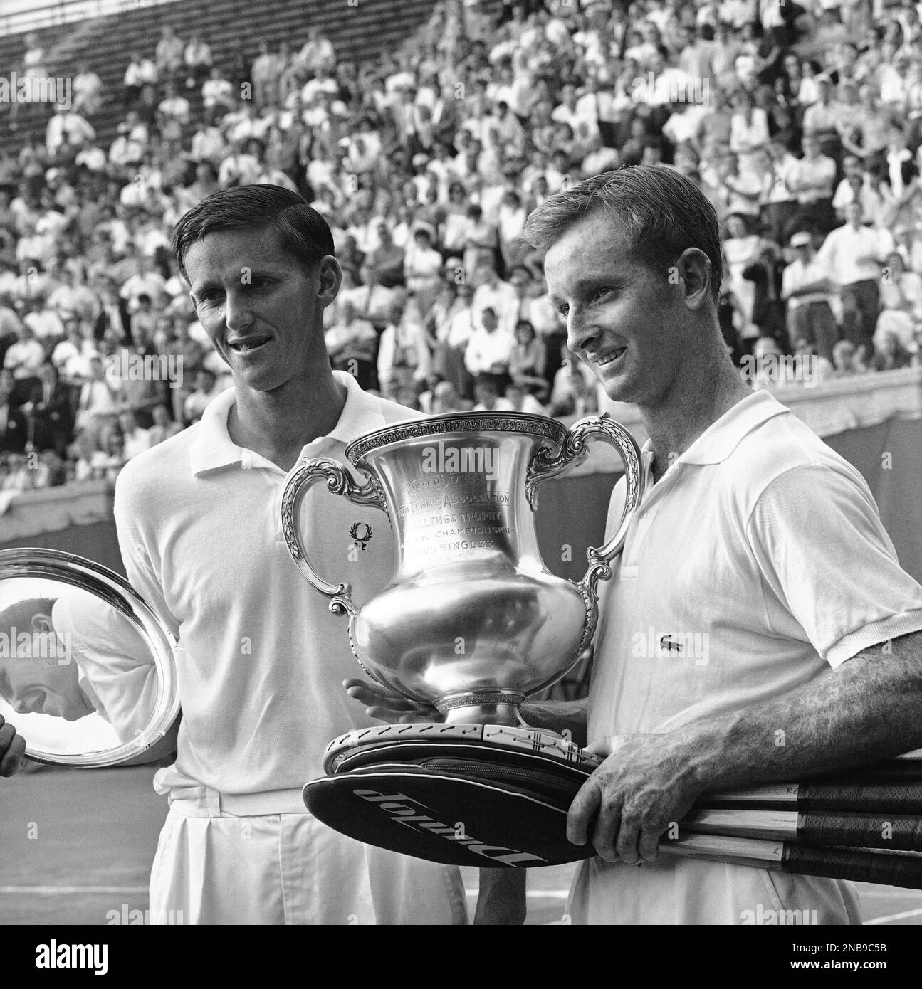 Roy Emerson, left, and Rod Laver hold trophies at Forest Hills 