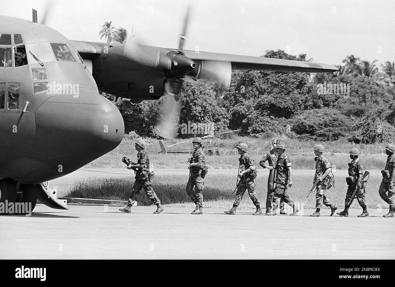 U.S. soldiers board a military cargo plane beginning their trip home from Grenada’s Pearls
