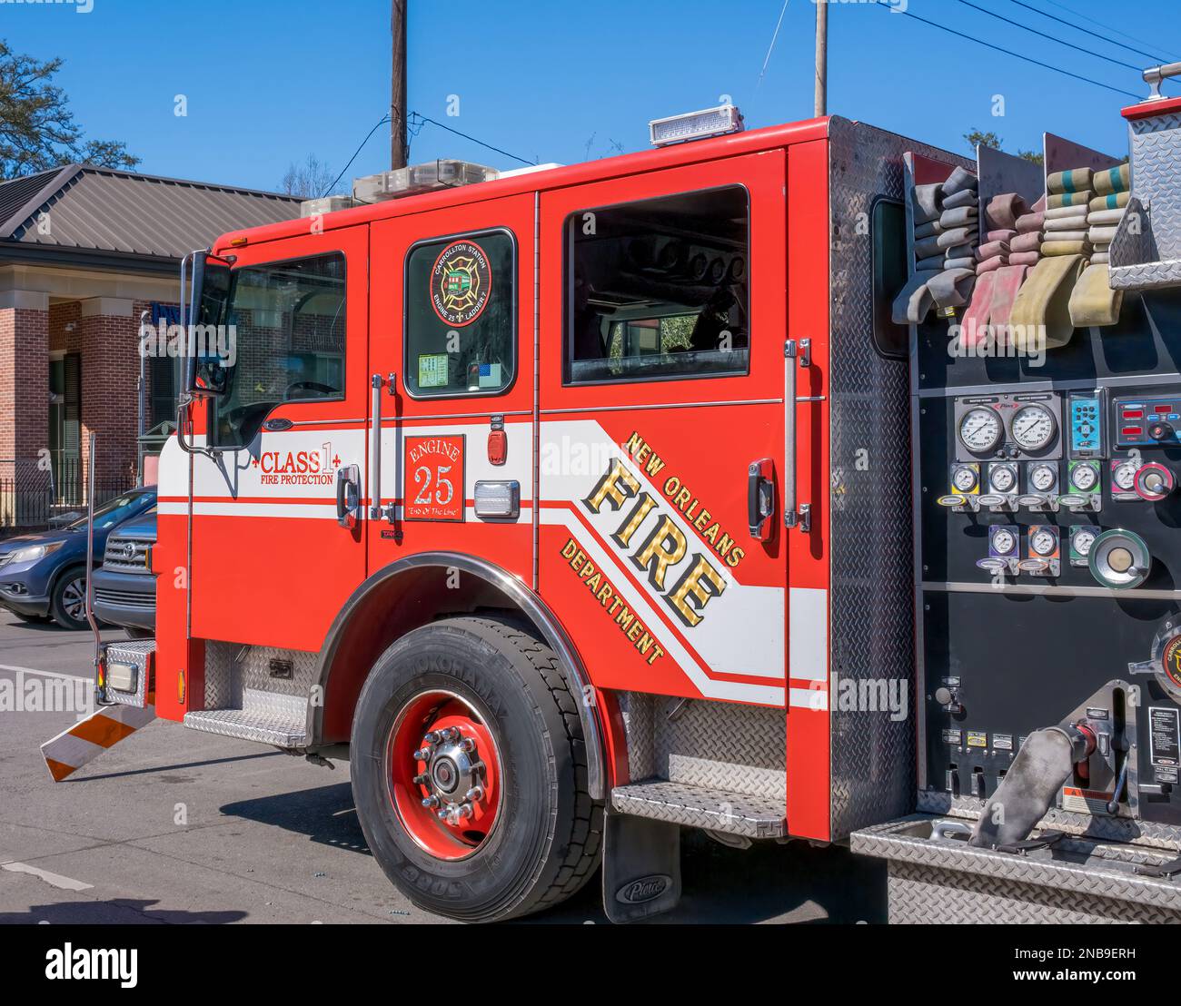 NEW ORLEANS, LA, USA - FEBRUARY 12, 2023: New Orleans Fire Department fire engine standing by along the Mardi Gras parade route at St. Charles Avenue Stock Photo