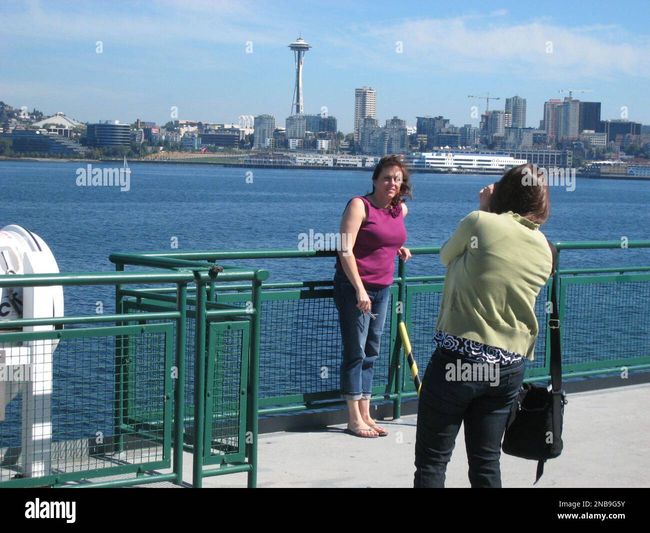 In this Aug. 24, 2011 photo taken at Bainbridge Island, Brittany Miller, of  Arroya Grande, Calif., takes a picture of her mother, Tami Miller, as they  travel on a Washington State Ferry,
