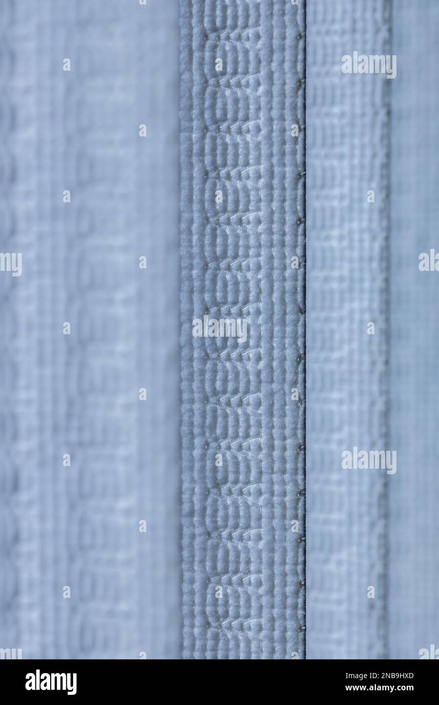 Defocused macro abstract texture background of a fabric vertical blinds surface in a light blue color Stock Photo