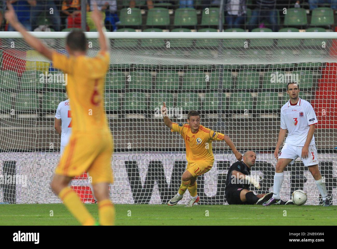 Romania's player Gabriel Torje, cheers as he scores during the Euro