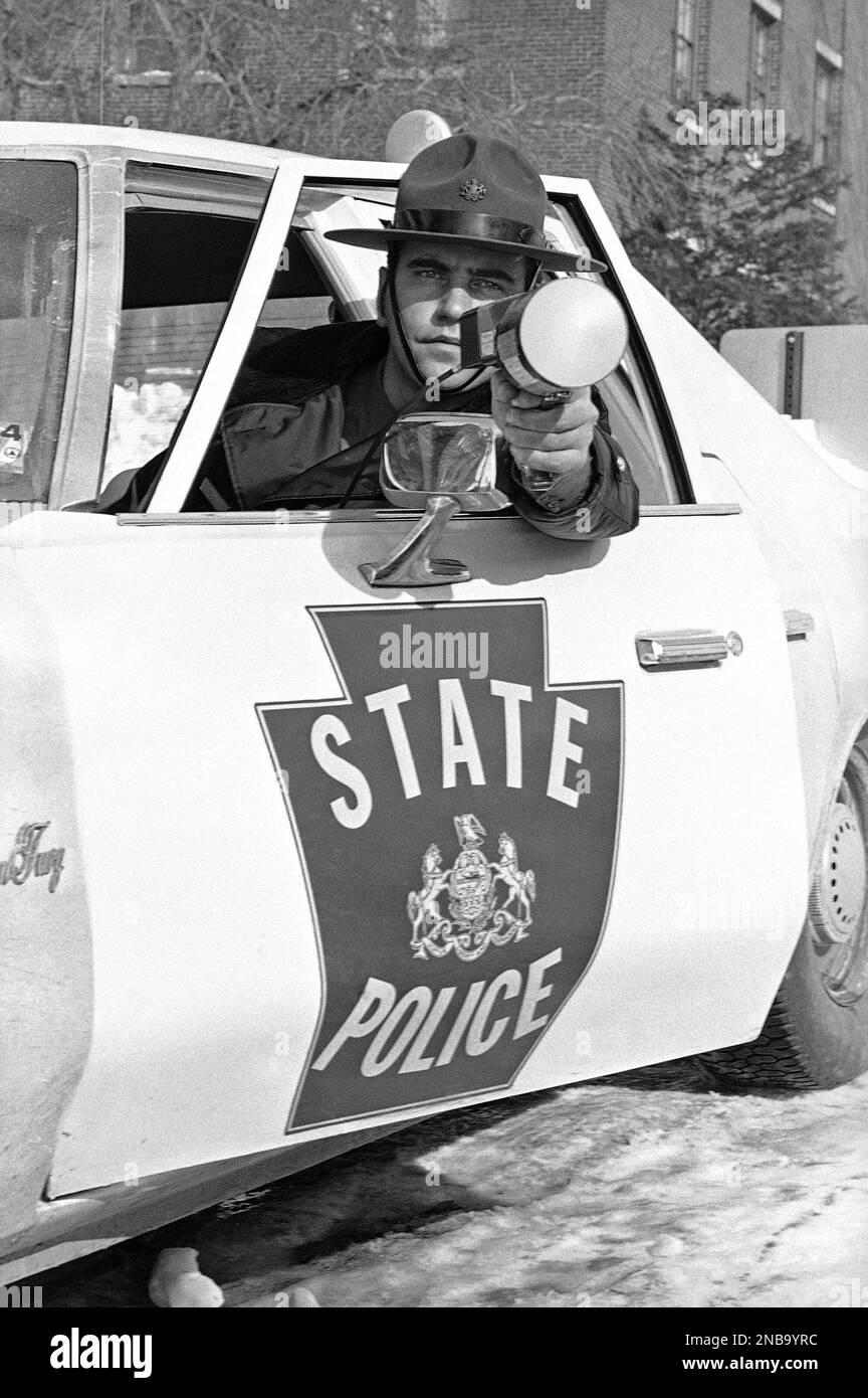 Pennsylvania State Police Trooper A. J. Probst leans out of window of
