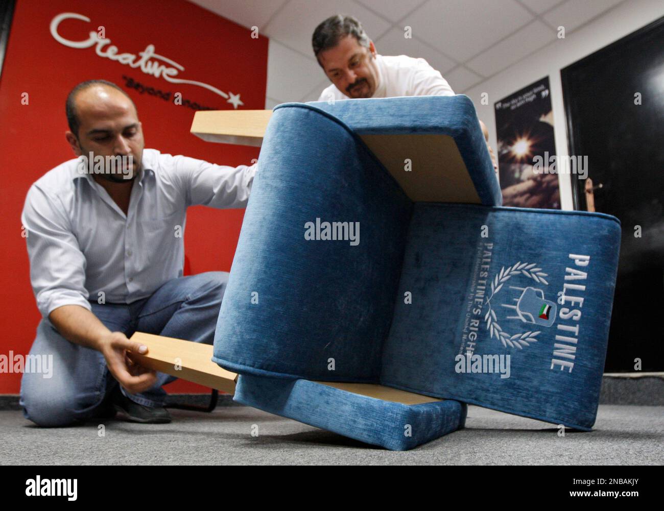 Palestinian Pattern Chair Palestinians assemble the legs of a chair covered with embroidered blue ...