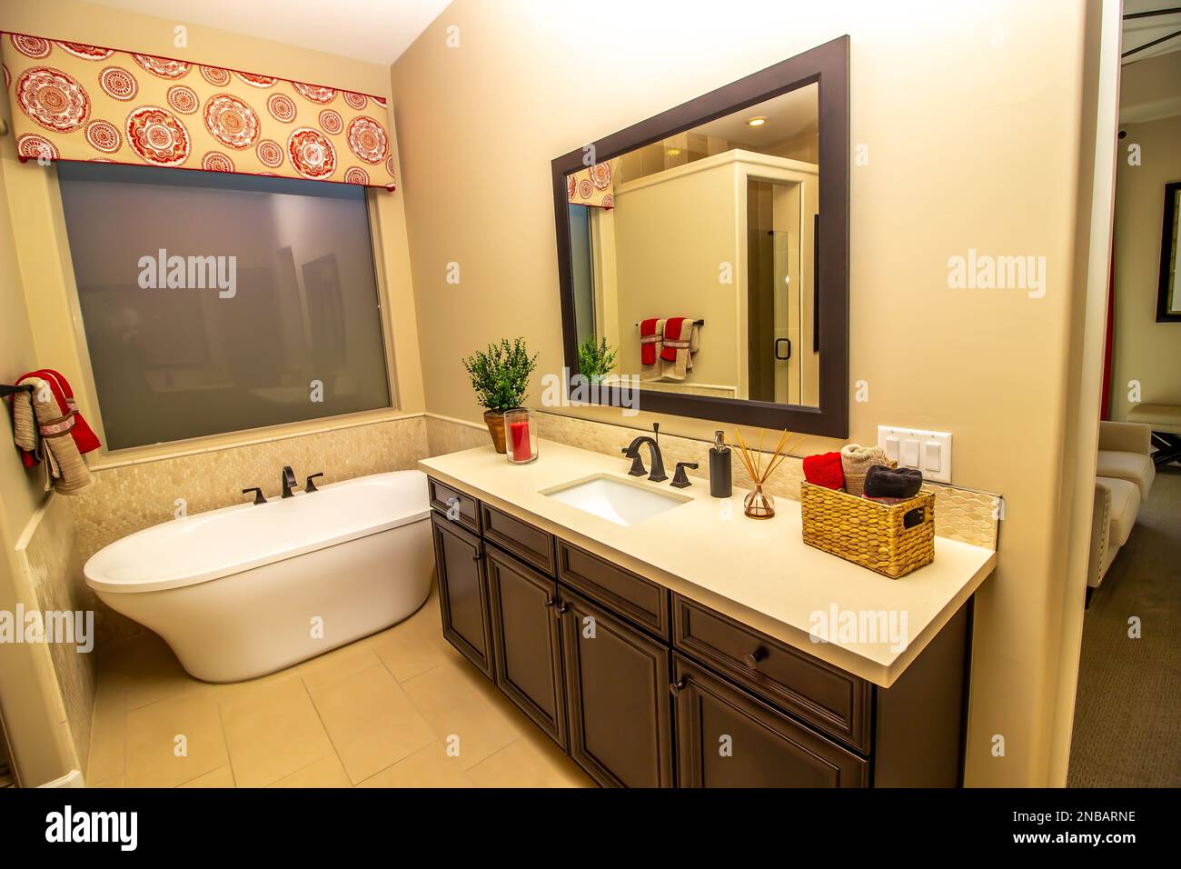 Master Bathroom Vanity With Mirror And Bath Tub Stock Photo - Alamy