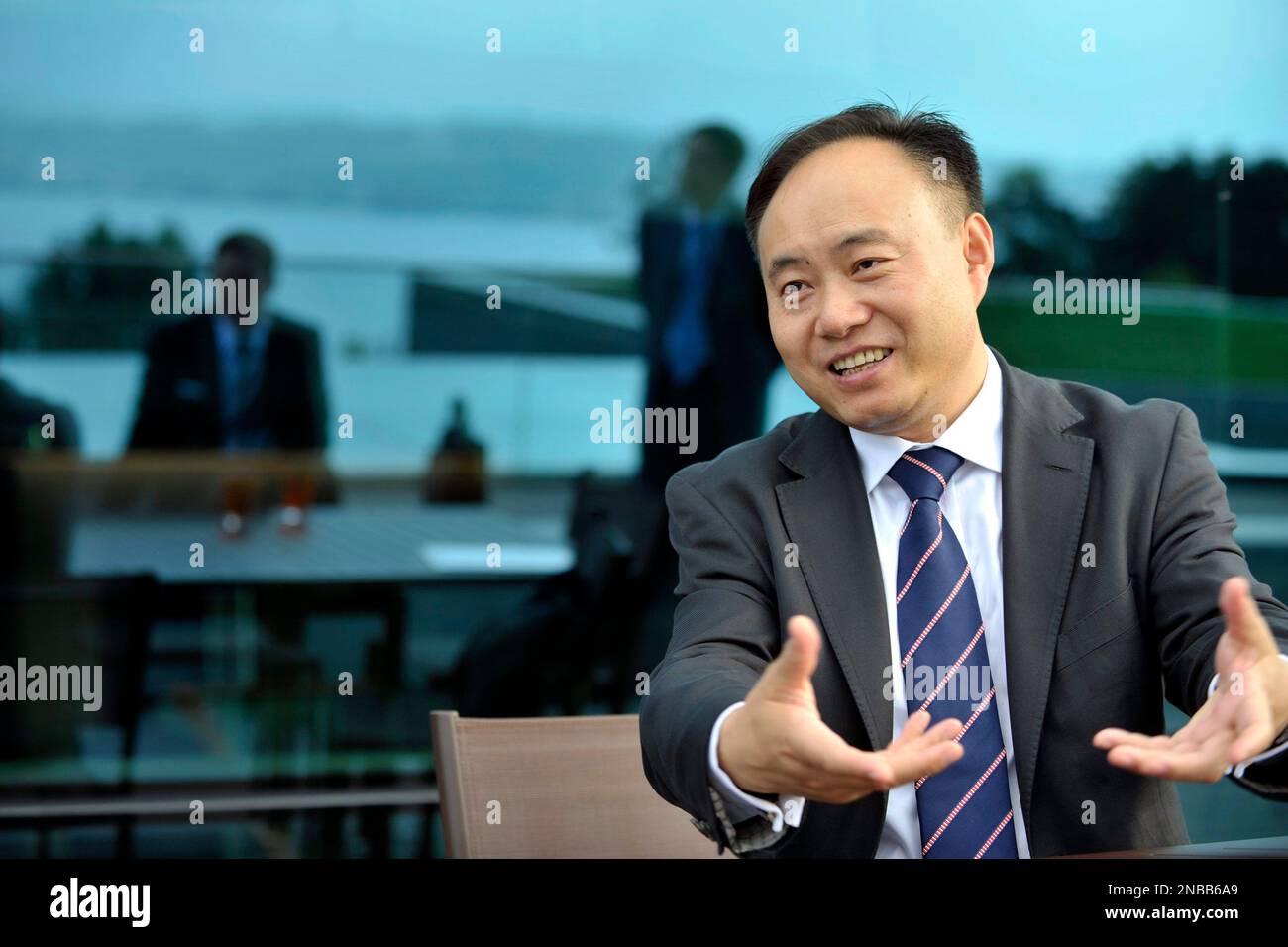 Zhengrong Shi, Founder and CEO of Suntech Power Co. Ltd., answers questions during an interview with the Associated Press at the WEF headquarters in Geneva, Switzerland, Thursday, Aug. 25. 2011. Shi Zhengrong, the CEO of Suntech Power Holdings Co., Ltd., said the G-20 advisory panel expects to issue a set of recommendations about five weeks from now on how world leaders can shift to solar, wind and other alternative energy sources - even in dire financial times. ( AP Photo/Keystone/Martial Trezzini) GERMANY OUT - AUSTRIA OUT Stock Photo