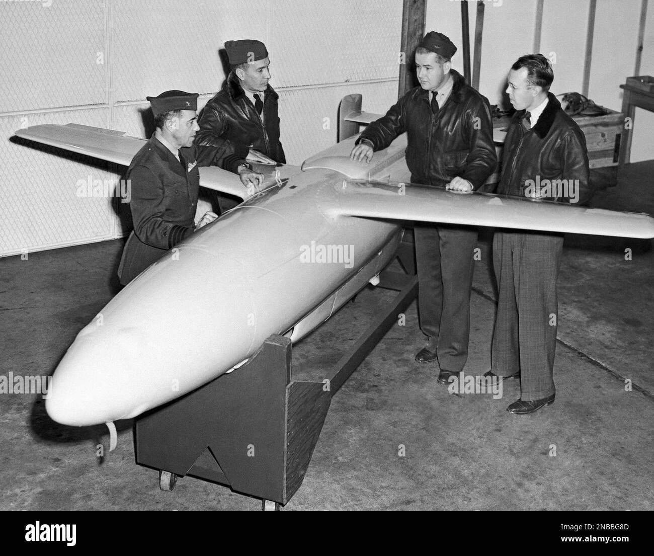 A “gorgon,” jet-propelled missile, is looked over by (left to right ...
