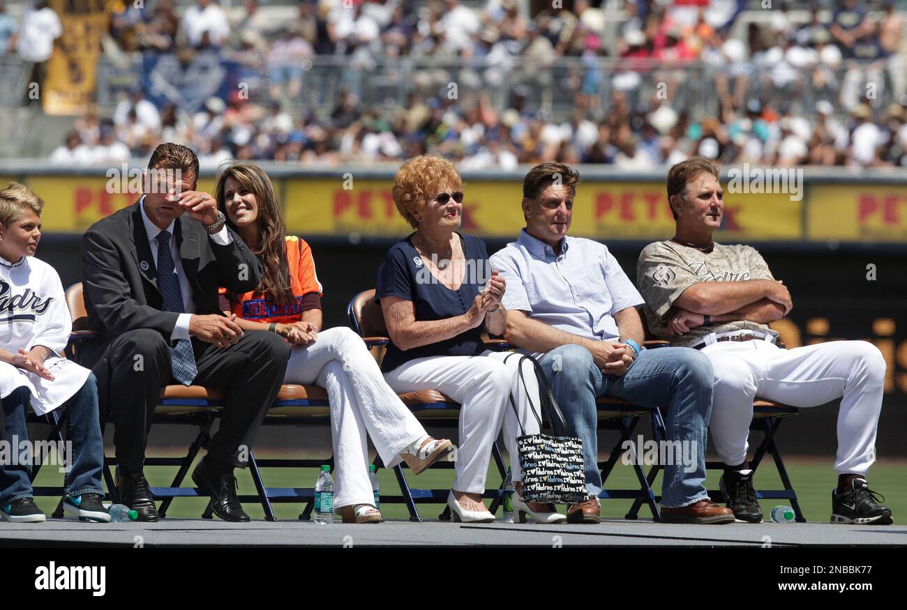 Former San Diego Padres pitcher Trevor Hoffman stands between his wife,  Tracy, and one of his sons as he looks at a standing ovation by fans during  his induction into the Padres
