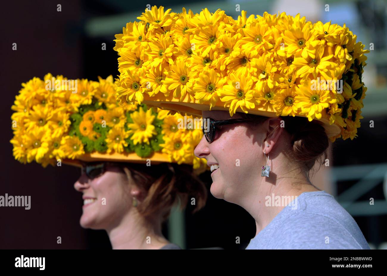 Nichole Campbell, left, and Barbie Gossen wear fresh flower covered  cheeseheads before an NFL preseason football game between the Green Bay  Packers and the Arizona Cardinals Friday, Aug. 19, 2011, in Green