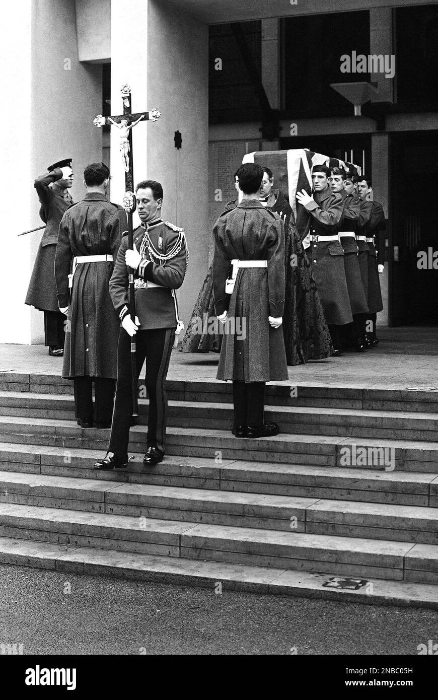 Shrouded in the Union Jack, and bearing his sword and cap, the coffin is carried by members of