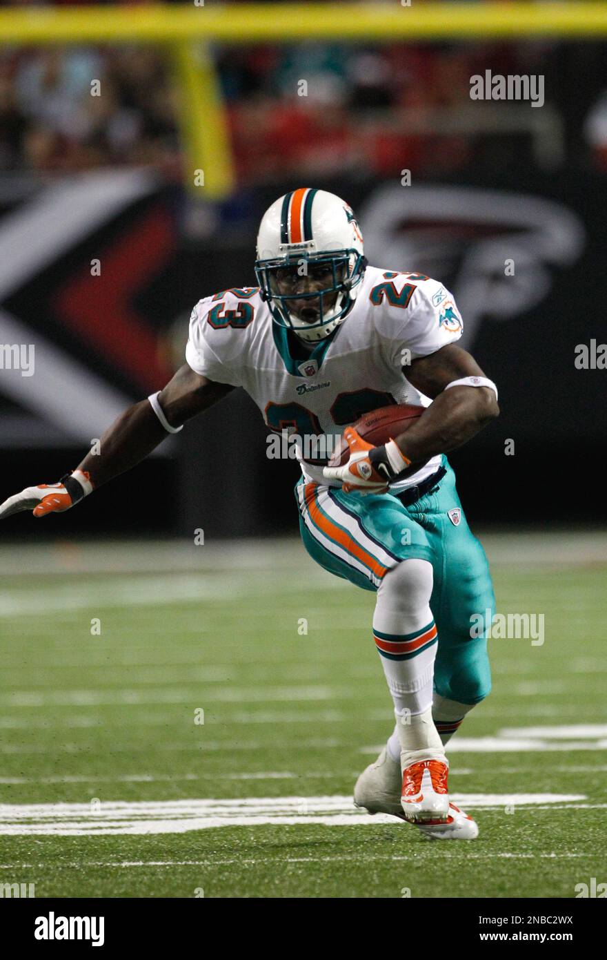 Miami Dolphins running back Kory Sheets (23) breaks the tackle of