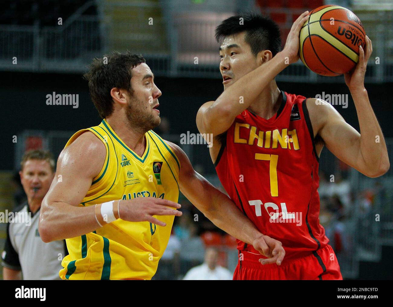 China's Shipeng Wang right, runs with the ball against Australia's Adam ...