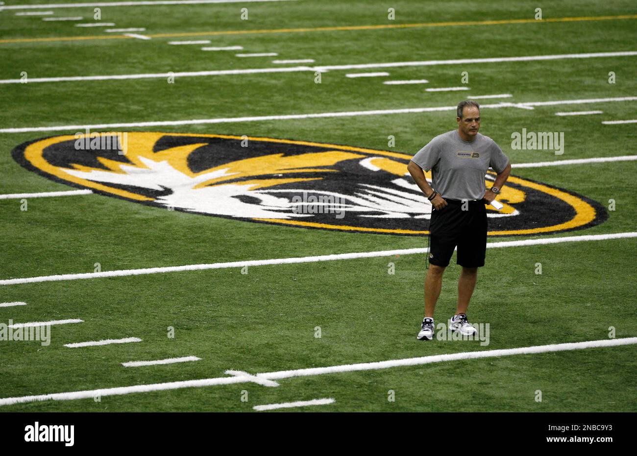 Missouri head coach Gary Pinkel stands among his players in the team's ...