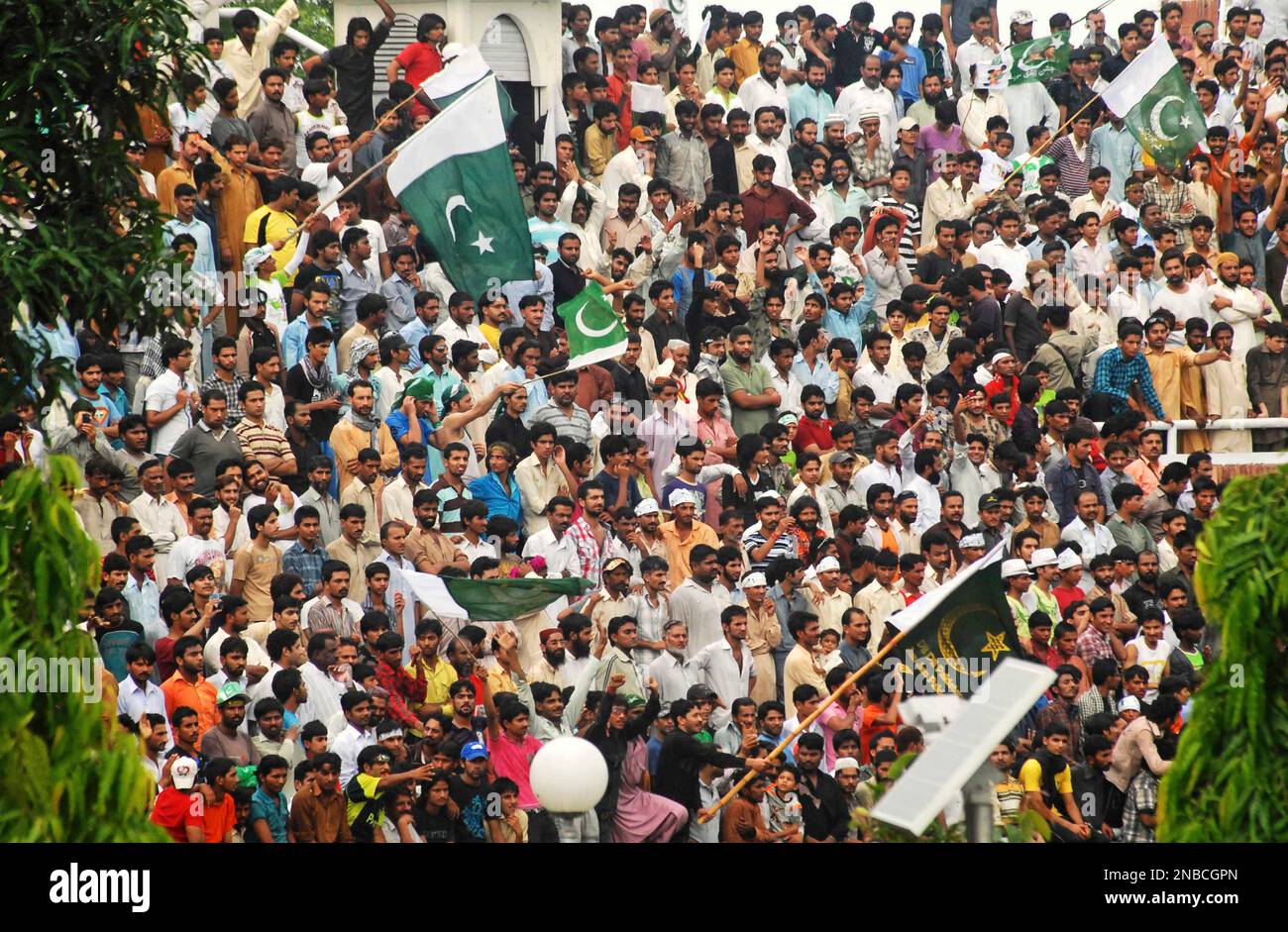 Pakistani people attending a flag-hoisting ceremony during Pakistan's ...