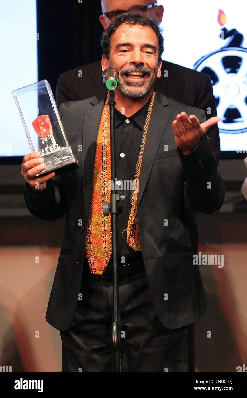 Mexican actor Damian Alcazar speaks as he holds his Spondylus trophy