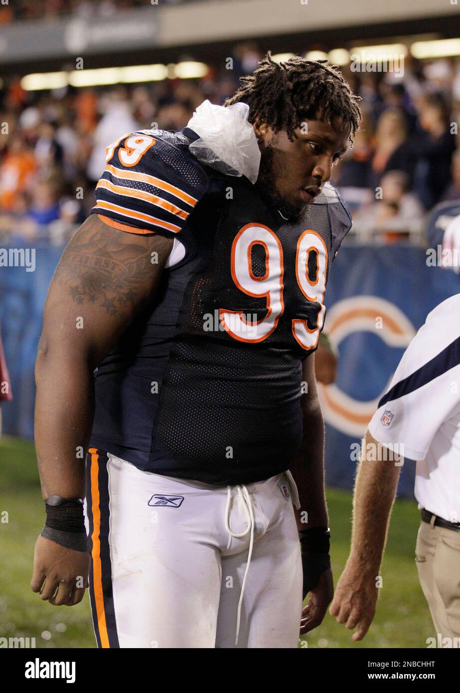 Chicago Bears defensive tackle Marcus Harrison (99) walks off the field  with an ice pack on his neck at the end of the first half of an NFL  preseason football game against