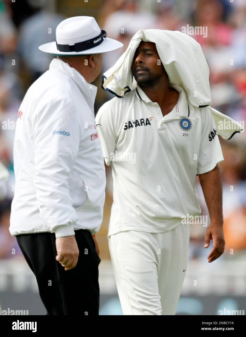 Umpire Steve Davis talks with India's Praveen Kumar after finishing his ...