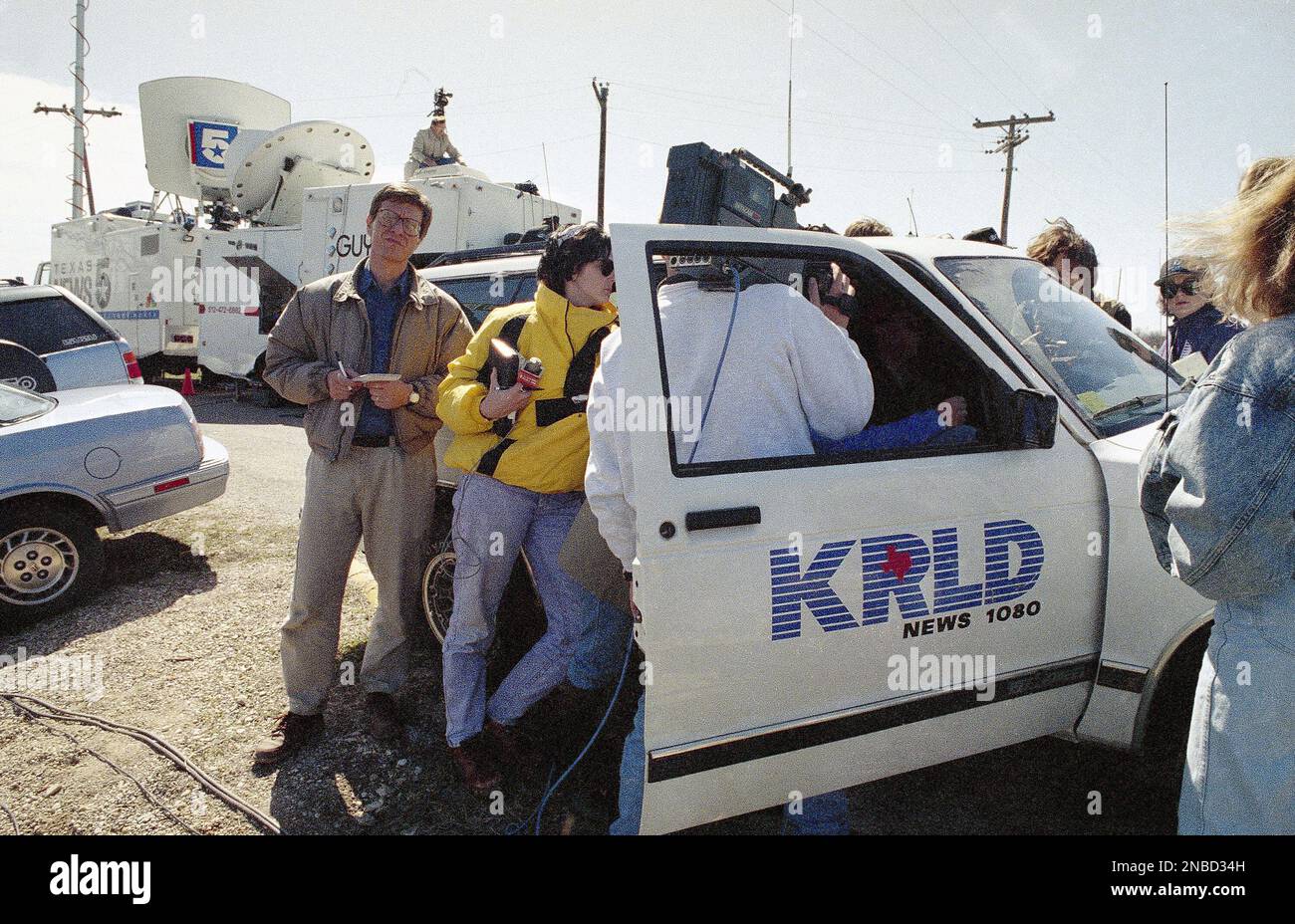 News people listen to David Koresh' taped radio address at the