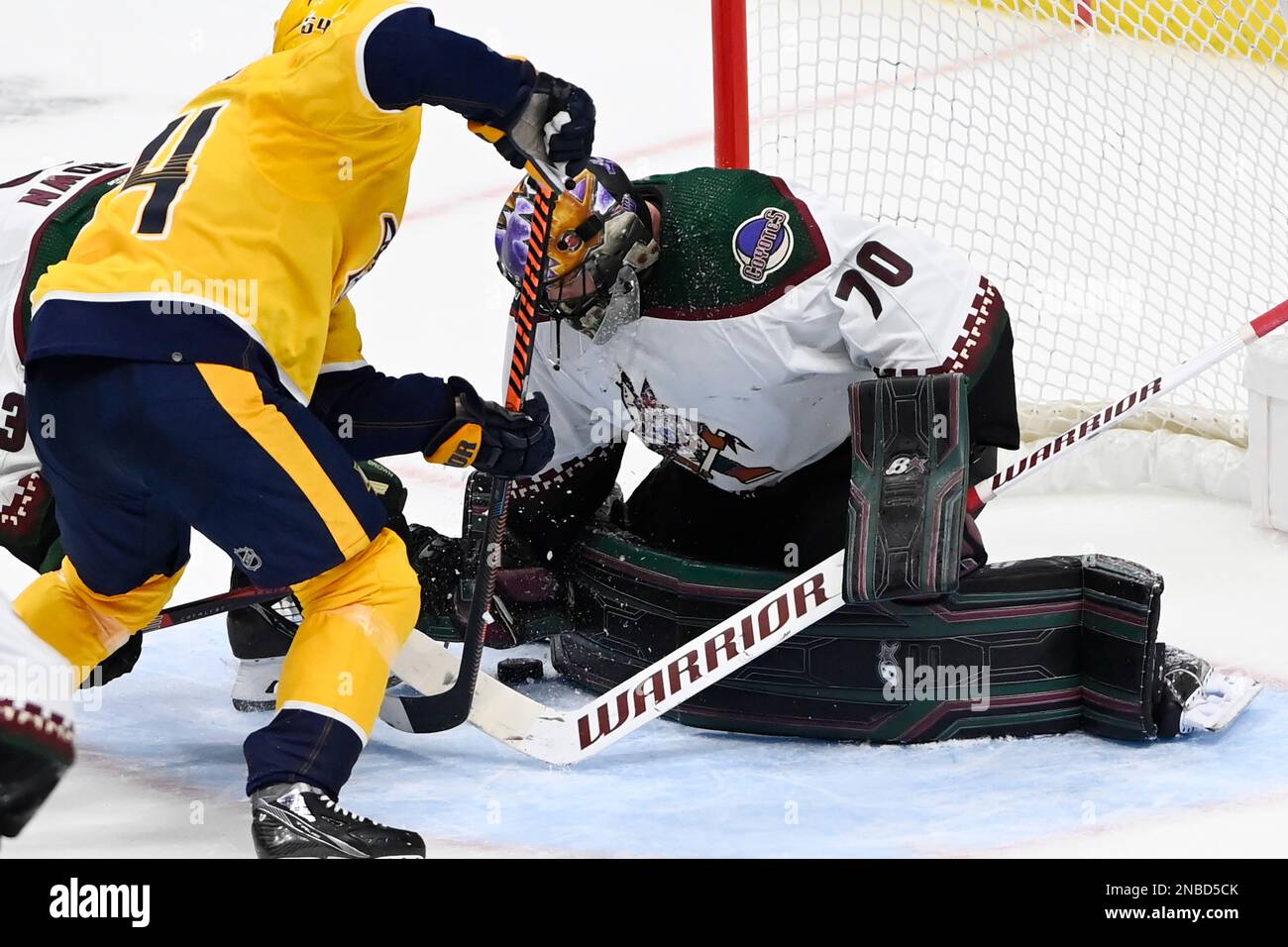 Arizona Coyotes goaltender Karel Vejmelka (70) covers the puck after a ...