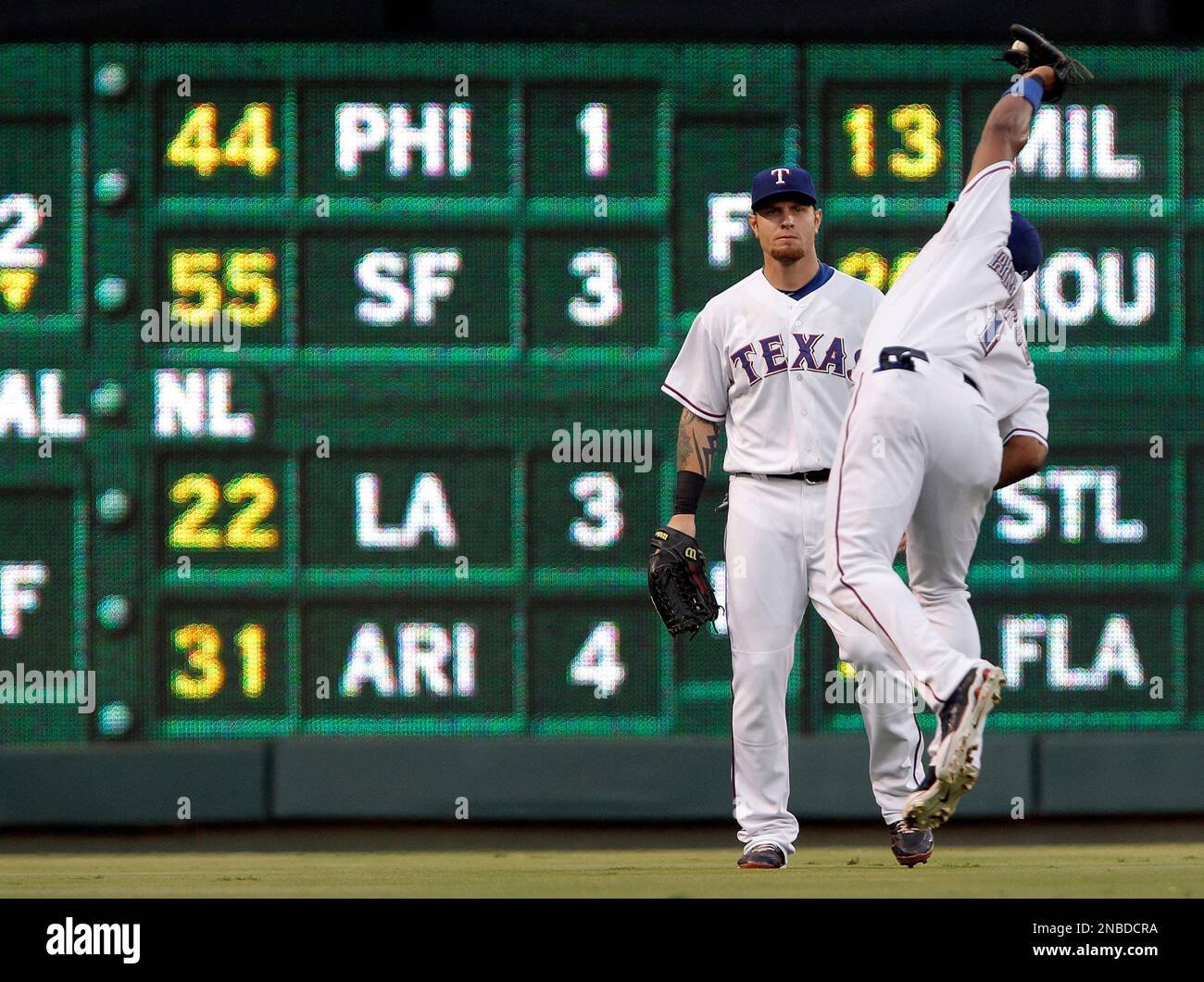 Texas Rangers' Josh Hamilton, left, reaches back to hit Elvis Andrus,  right, on the head with a rosin bag as the two joke around during a  baseball team practice for the World