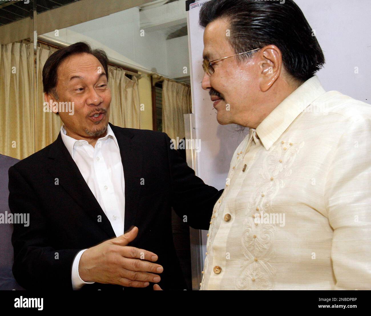 Former Malaysian Deputy Prime Minister Anwar Ibrahim, left, reacts as 