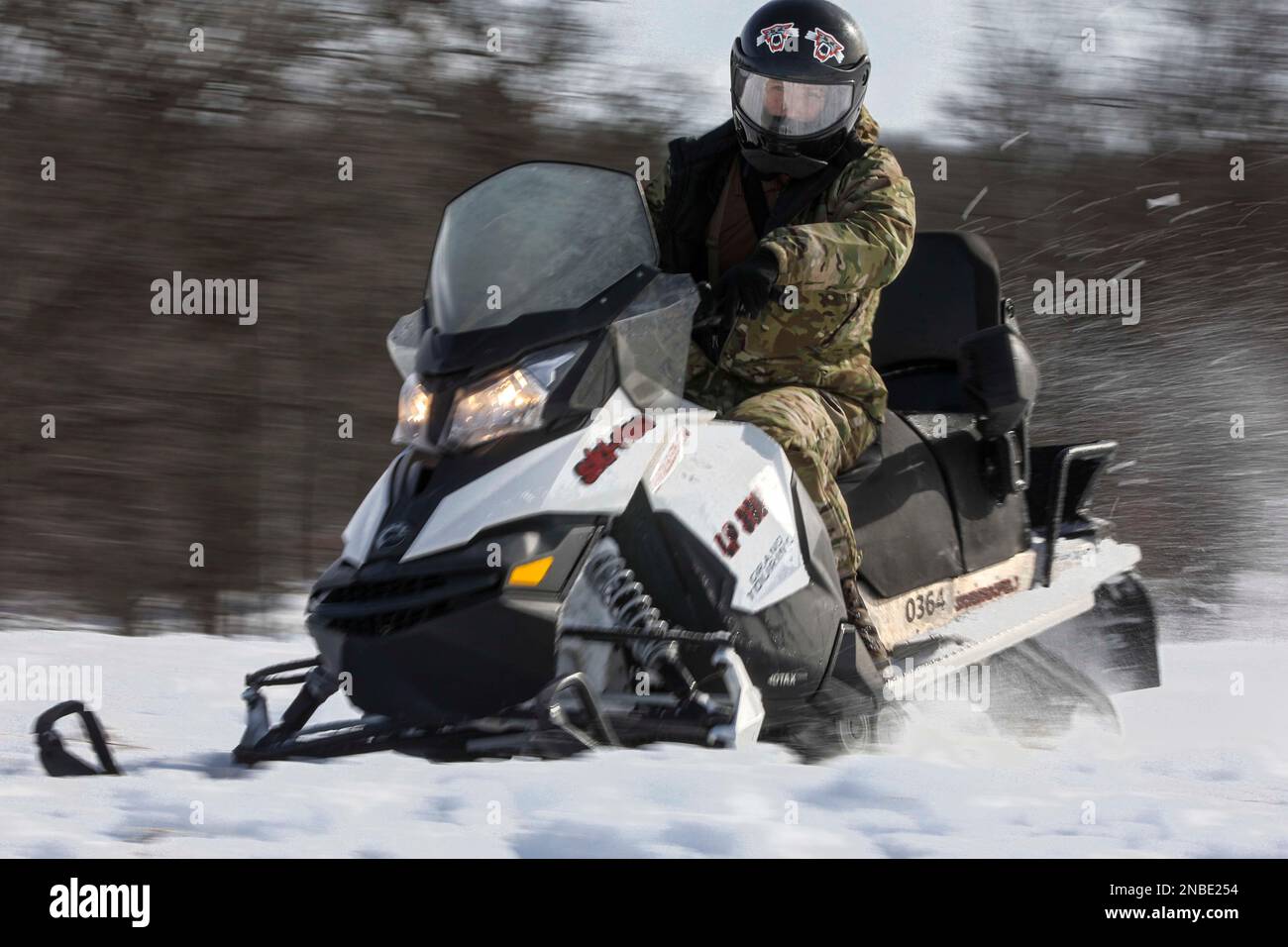 LITTLE FALLS, Minn. (Feb. 9, 2023) – A U.S. Navy Explosive Ordnance Disposal (EOD) Technician, assigned to EOD Mobile Unit Two, drives a snowmobile during Arctic mobility training in Little Falls, Minnesota, Feb. 9, 2023 during Snow Crab Exercise 23-1, an exercise designed to test and evaluate U.S. Navy Explosive Ordnance Disposal’s (EOD) and Navy Diver’s capabilities and equipment in a simulated Arctic environment and improve combat effectiveness. Navy EOD and Navy Divers are part of the Navy Expeditionary Combat Force (NECF), enabling the U.S. Navy Fleet by clearing and protecting the battle Stock Photo