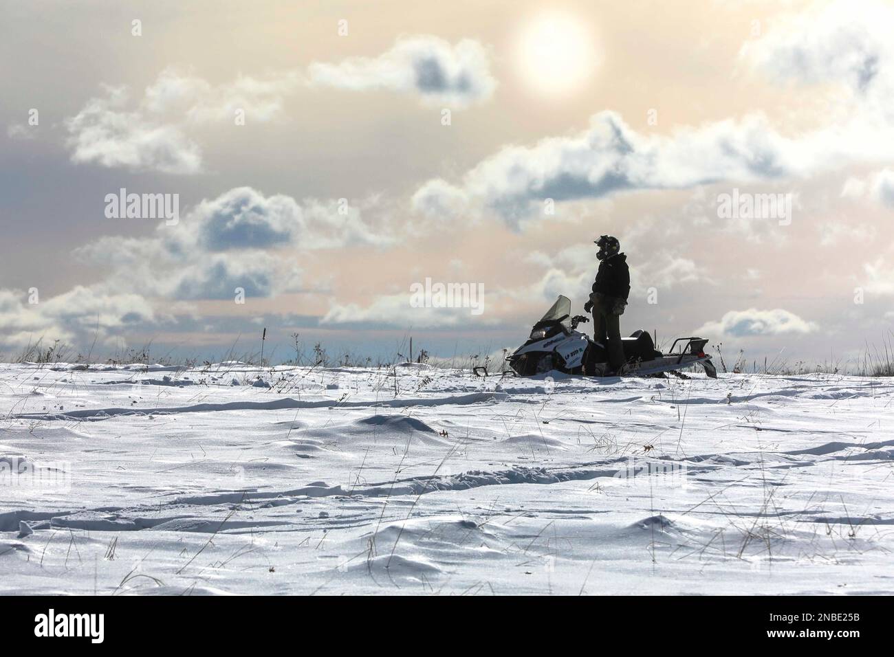 LITTLE FALLS, Minn. (Feb. 9, 2023) – A U.S. Navy Explosive Ordnance Disposal (EOD) Technician, assigned to EOD Mobile Unit Two, stands in a snowmobile during Arctic mobility training in Little Falls, Minnesota, Feb. 9, 2023 during Snow Crab Exercise 23-1, an exercise designed to test and evaluate U.S. Navy Explosive Ordnance Disposal’s (EOD) and Navy Diver’s capabilities and equipment in a simulated Arctic environment and improve combat effectiveness. Navy EOD and Navy Divers are part of the Navy Expeditionary Combat Force (NECF), enabling the U.S. Navy Fleet by clearing and protecting the bat Stock Photo