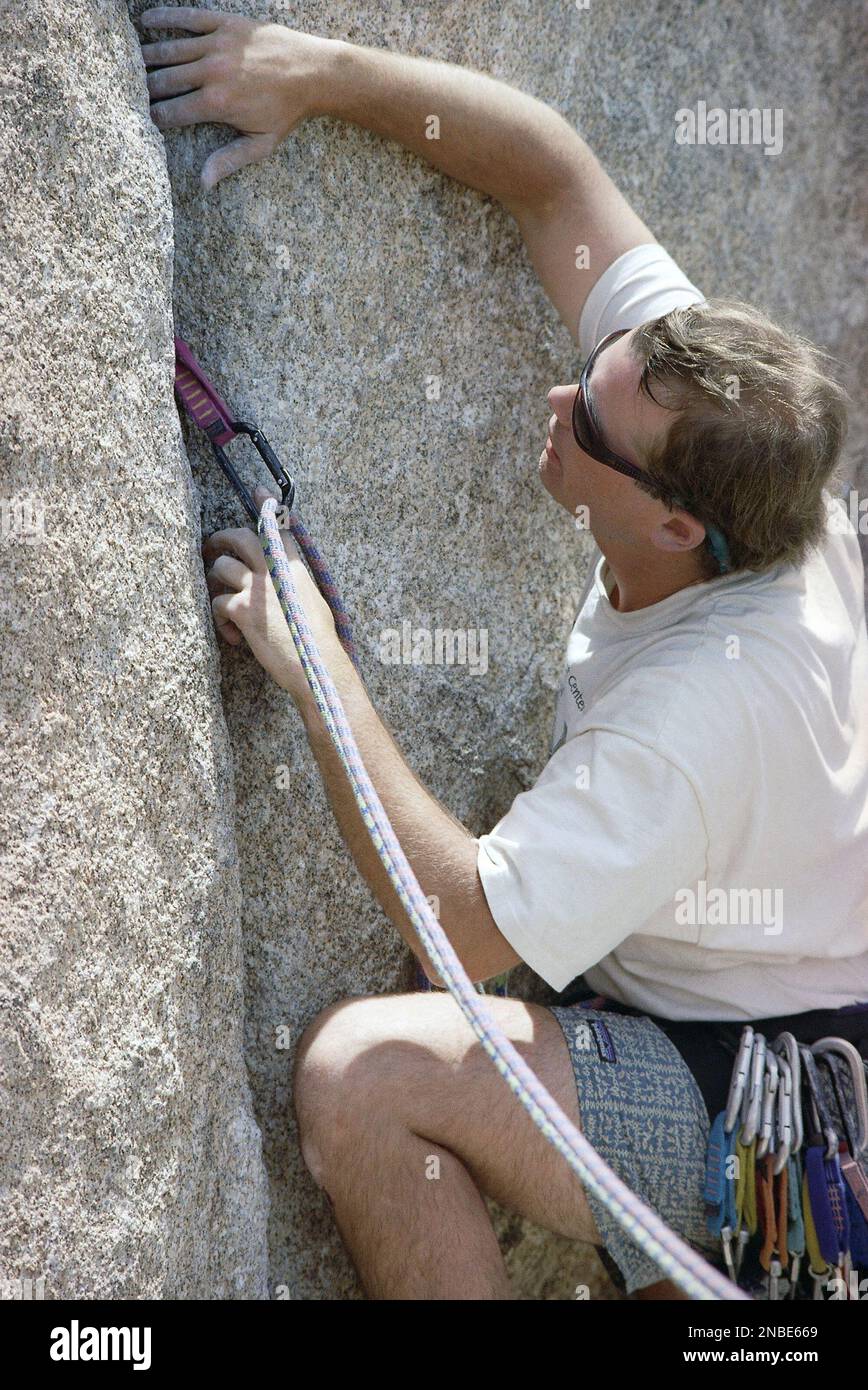 A Rope Clipped Into A Carabiner Attached To A Piece Of Climbing Hardware Will Keep Climber Matt