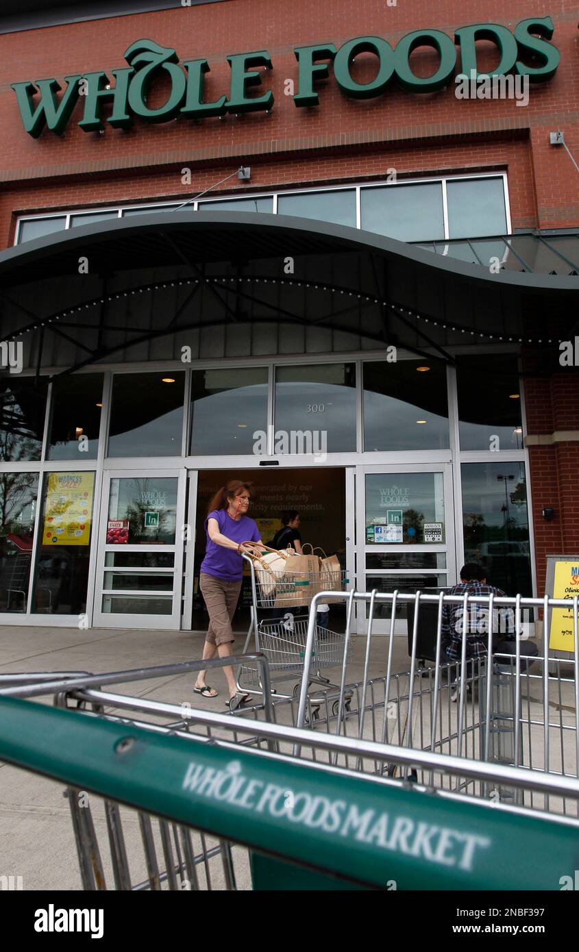 In this July 25, 2011 photo, a shopper departs a Whole Foods Market