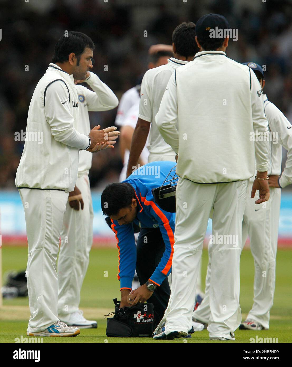 India's Mahendra Singh Dhoni has new bandages put on his fingers during