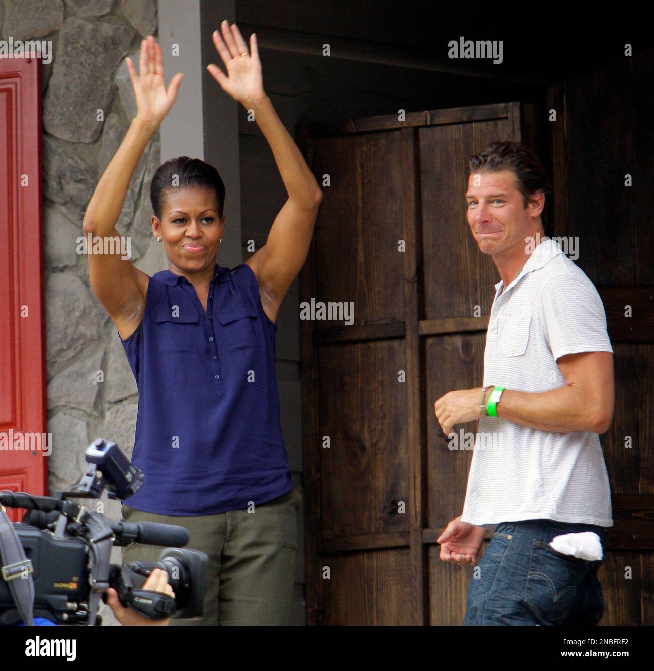 First lady Michelle Obama waves as she and Ty Pennington, host of