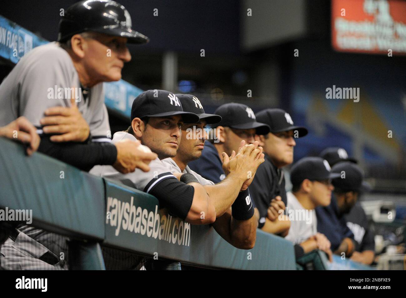 New York Yankees watch from the dugout during the ninth inning of their 4-0 win in a baseball game against the Tampa Bay Rays on Wednesday, July 20, 2011, in St. Petersburg, Fla. (AP Photo/Brian Blanco) Stock Photo
