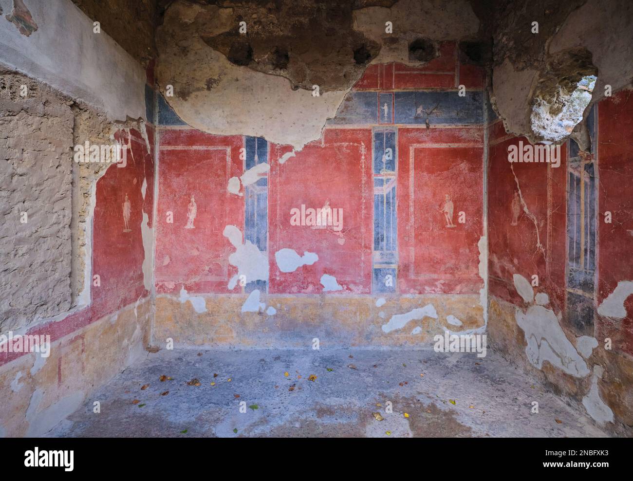 A room, covered in red fresco work at House of Octavius Quartio. At Pompeii Archaeological Park near Naples, Italy. Stock Photo
