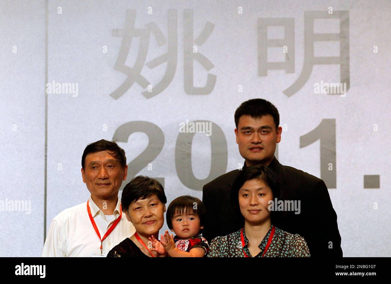 Standing in front of his name in Chinese characters, NBA star Yao Ming